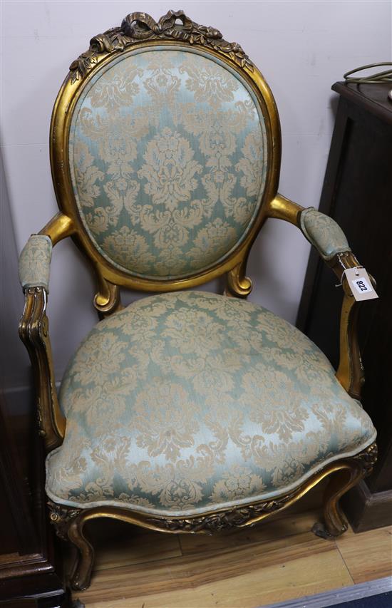 A pair of gilt elbow chairs